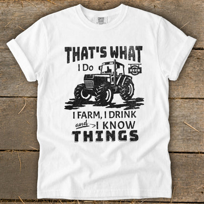White t-shirt with "That's What I Do, I Farm, I Drink and I Know Things" and tractor graphic.