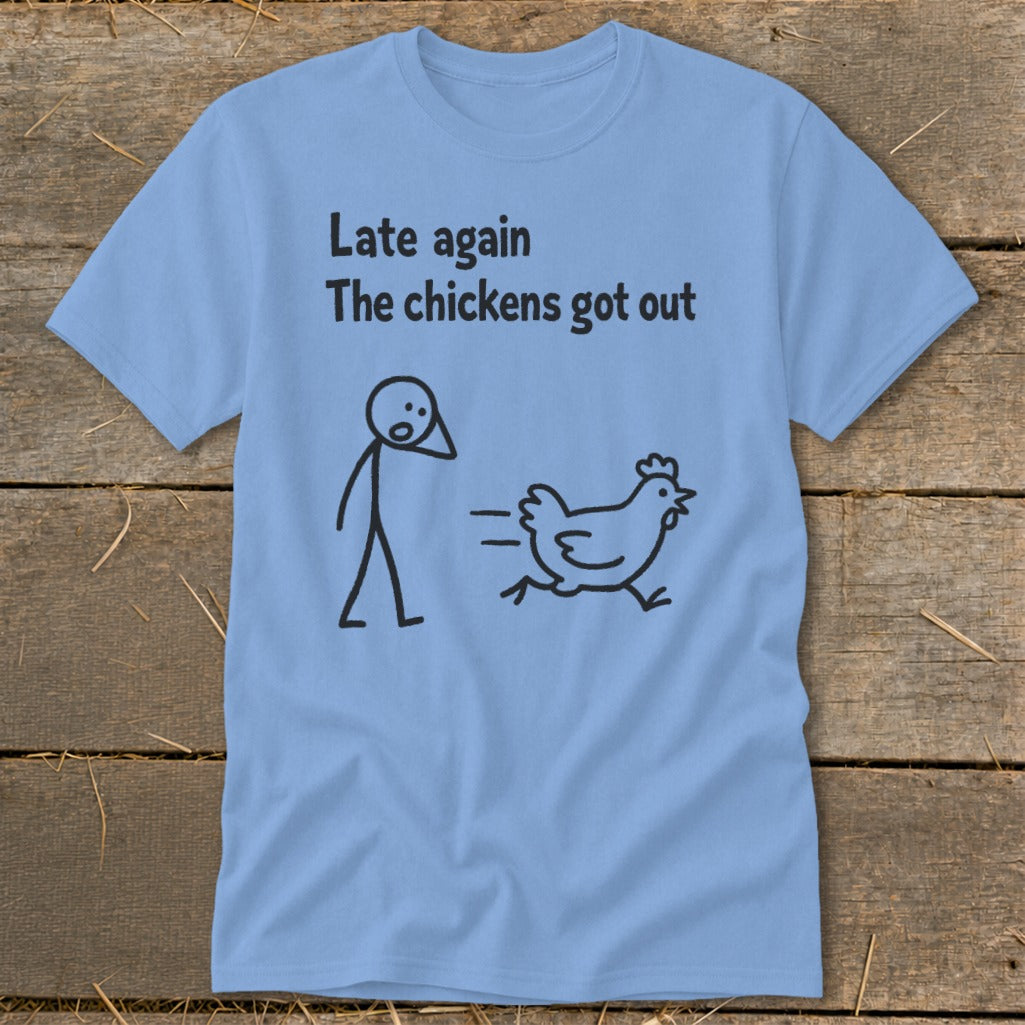 Light blue t-shirt with black text and stick figure drawing of a running chicken and startled person.