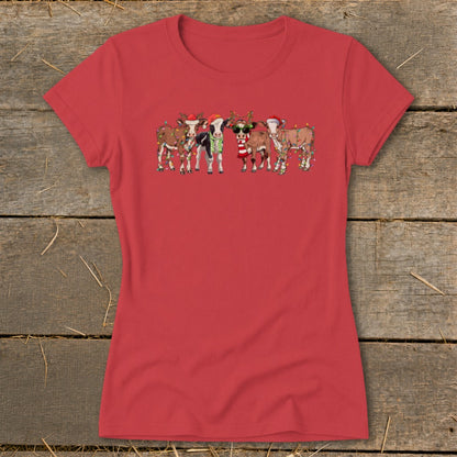 Cartoon cows wearing Santa hats and Christmas lights on a red t-shirt.