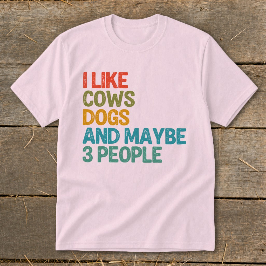 Light pink t-shirt with "I like cows dogs and maybe 3 people" text.