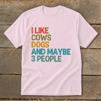 Light pink t-shirt with "I like cows dogs and maybe 3 people" text.