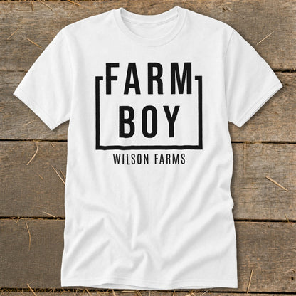 White t-shirt with black text: FARM BOY in a box, below it WILSON FARMS.