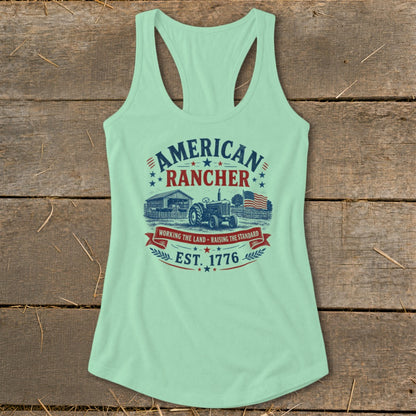 Mint green tank top with "American Rancher" graphic, tractor, barn, and American flag.