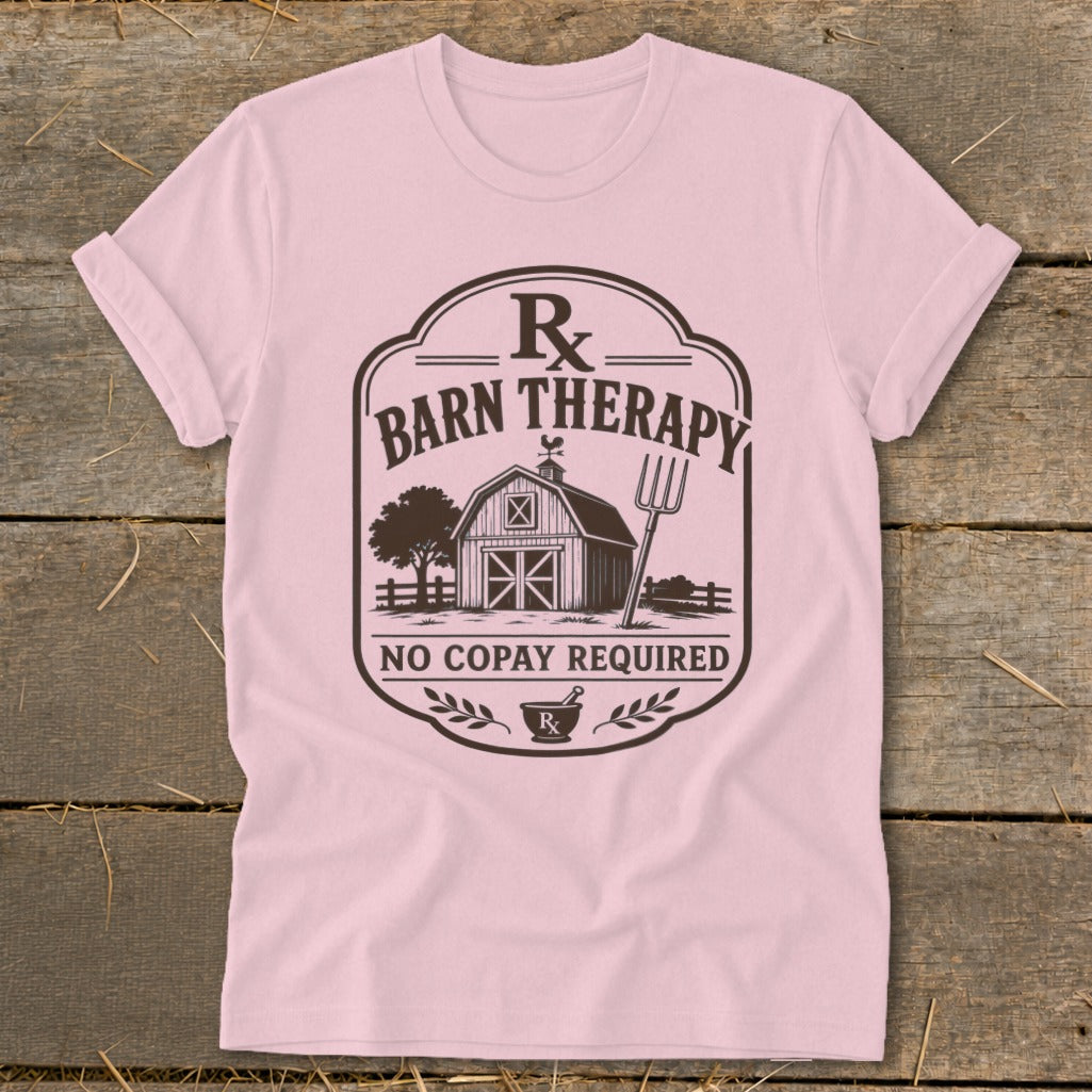 Pink t-shirt with "Barn Therapy" graphic and a barn, tree, and pitchfork illustration.