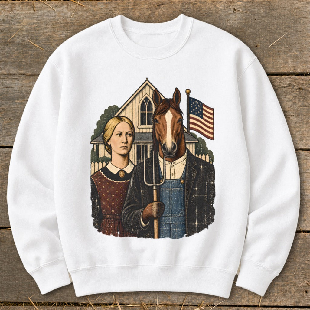 A white crewneck sweatshirt featuring a graphic parody of American Gothic with a horse holding a pitchfork.