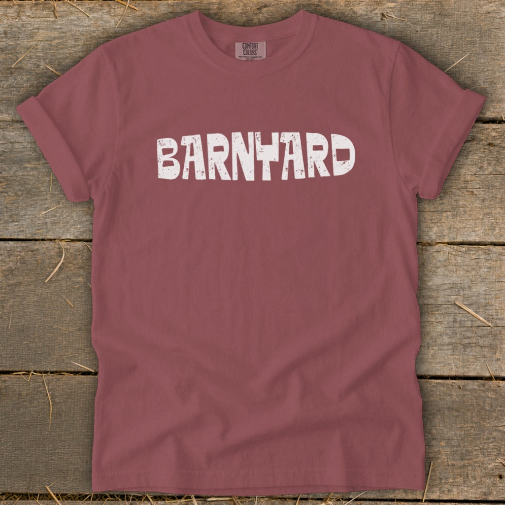 A maroon t-shirt with rolled sleeves features white distressed text that reads BARNYARD across the chest.