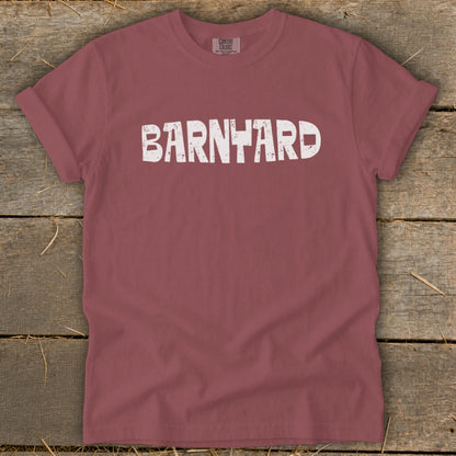 A maroon t-shirt with rolled sleeves features white distressed text that reads BARNYARD across the chest.