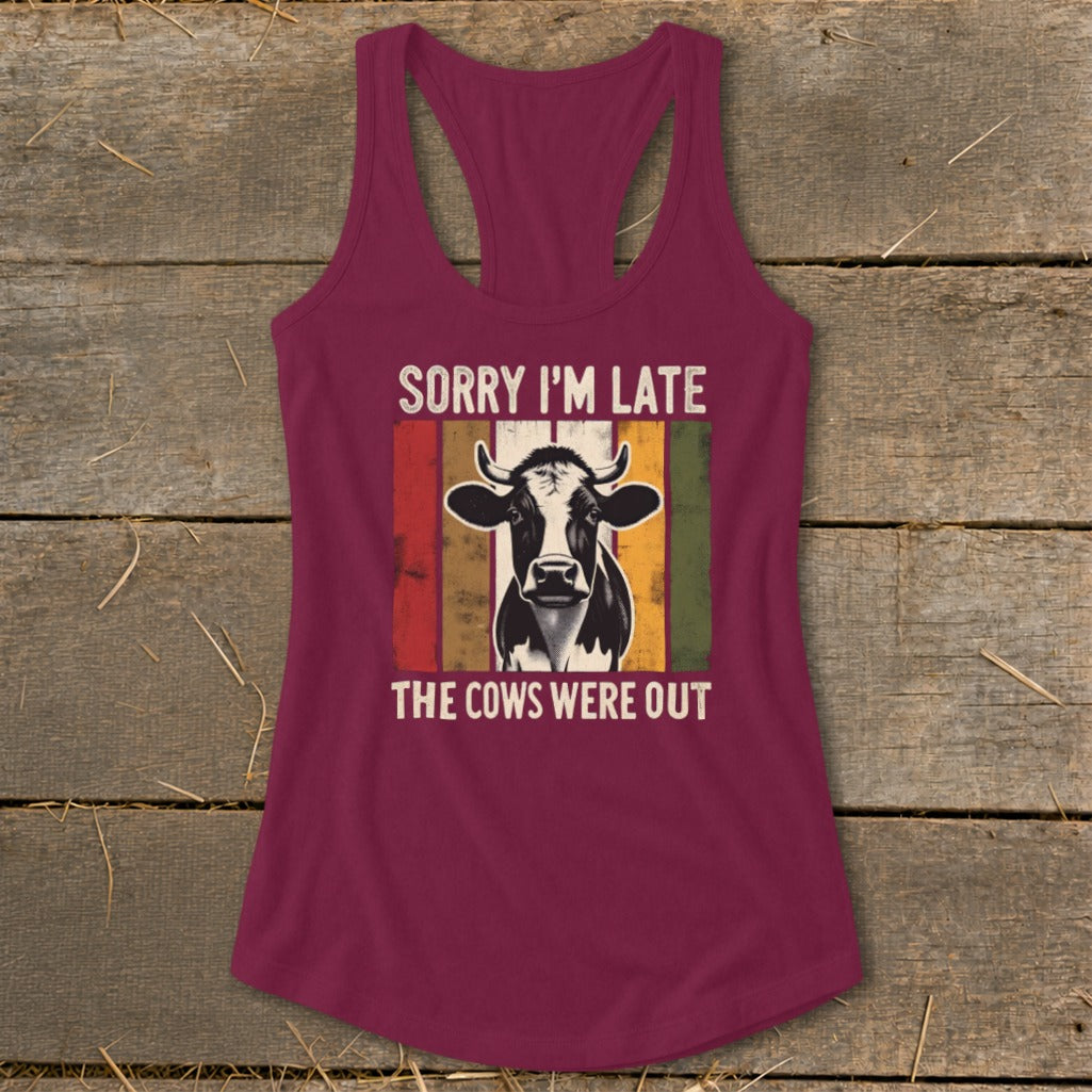 Burgundy tank top with a cow graphic and text "SORRY I'M LATE THE COWS WERE OUT".