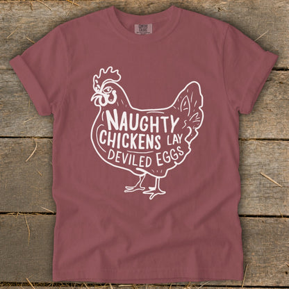Maroon t-shirt with white graphic of a chicken and text "Naughty Chickens Lay Deviled Eggs".