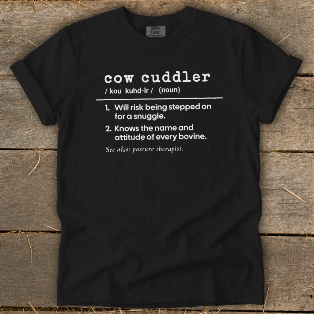 Black t-shirt with "cow cuddler" definition and humorous descriptions.