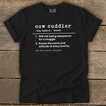 Black t-shirt with "cow cuddler" definition and humorous descriptions.