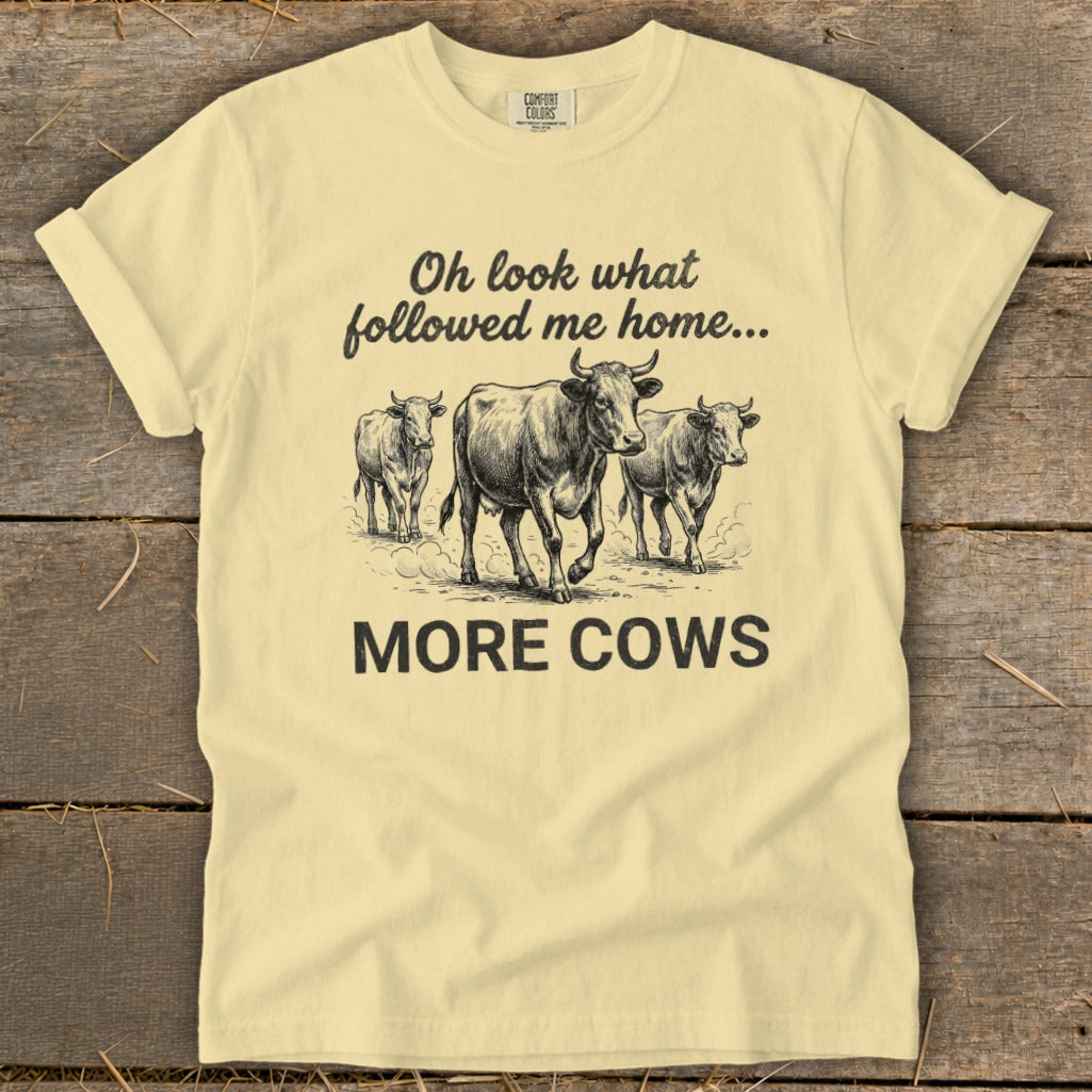 Yellow t-shirt with "Oh look what followed me home... MORE COWS" and drawing of three cows.
