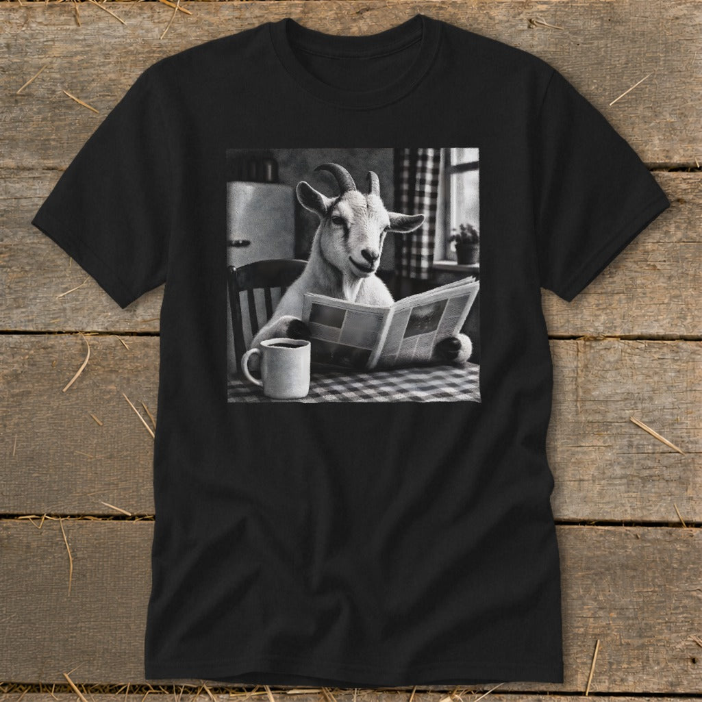 Black crewneck t-shirt featuring a black and white graphic of a goat reading a newspaper at a table with a mug.