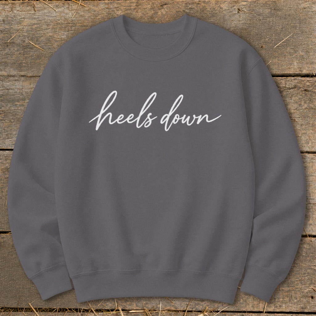 Gray crewneck sweatshirt with white cursive text "heels down".