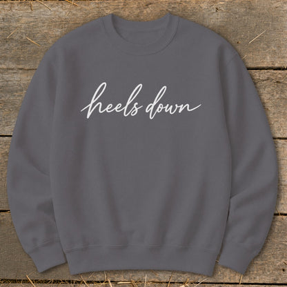 Gray crewneck sweatshirt with white cursive text "heels down".