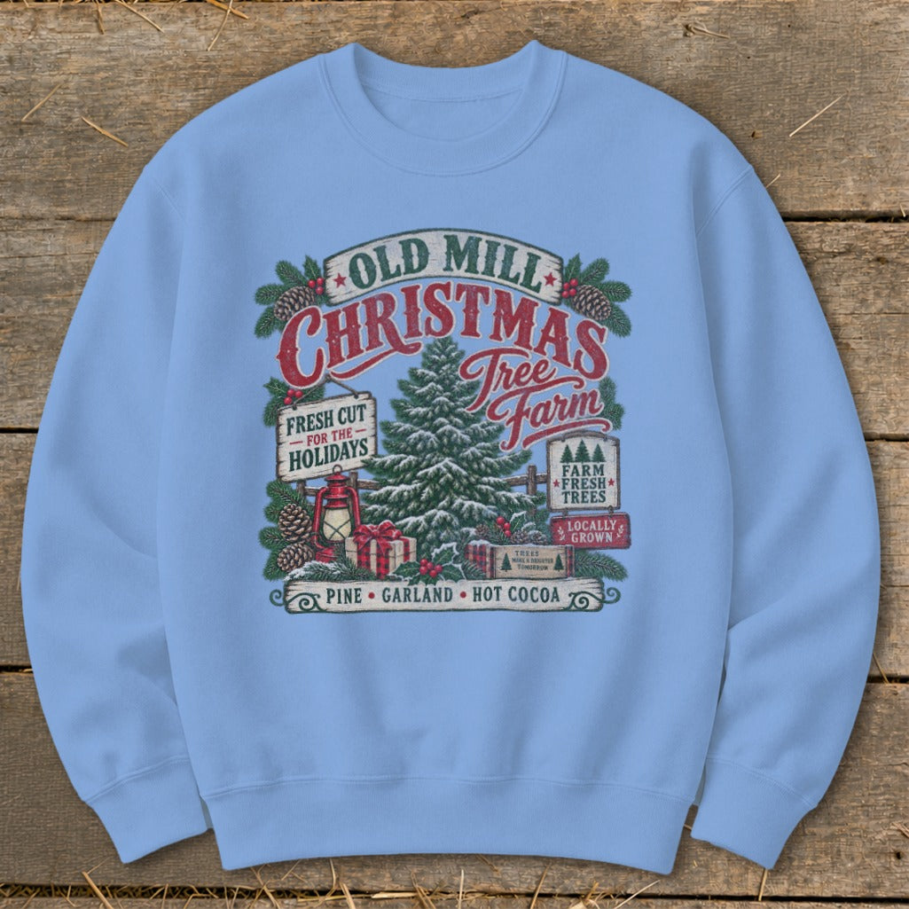 Light blue sweatshirt with Old Mill Christmas Tree Farm graphic featuring a tree, lantern, gifts, and festive text.