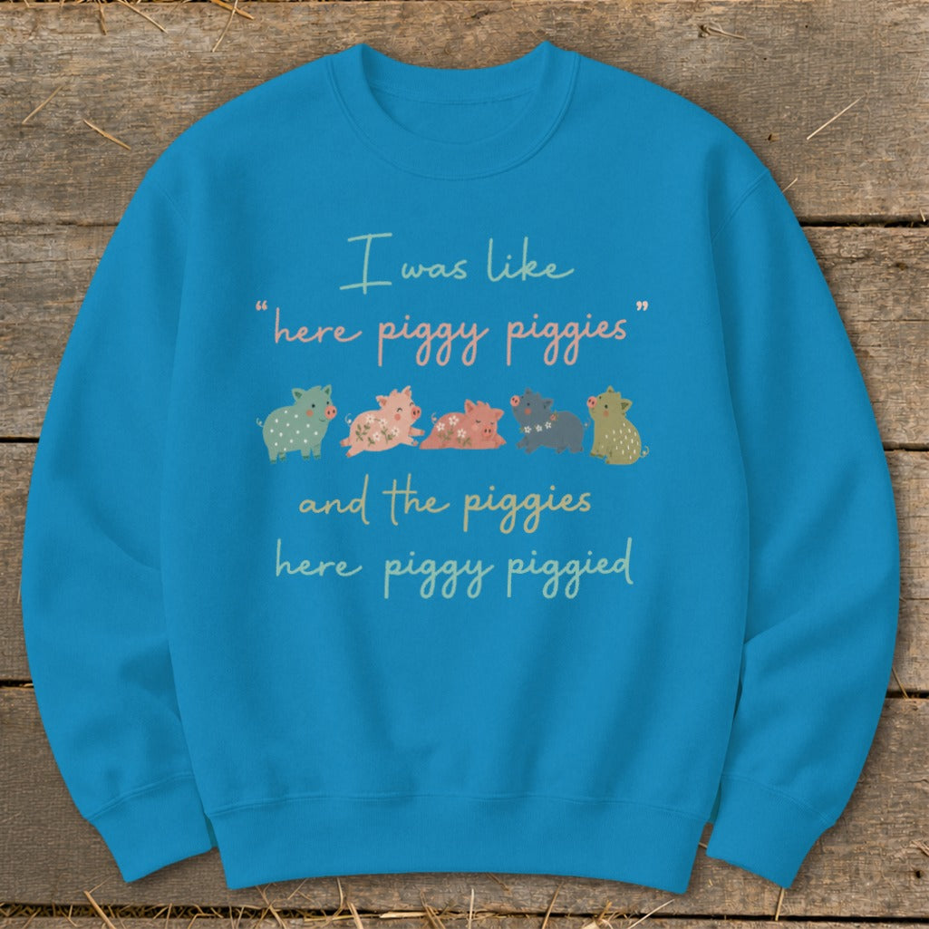 Blue sweatshirt with text "I was like 'here piggy piggies' and the piggies here piggy piggyed" and cartoon pigs.