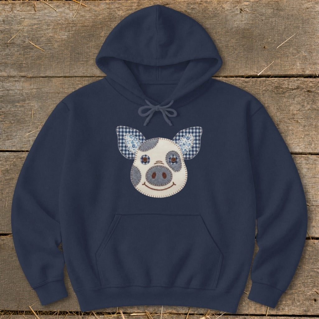 Navy hoodie with a patchwork pig face applique on the chest.