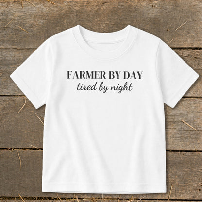 White t-shirt with "FARMER BY DAY tired by night" text.