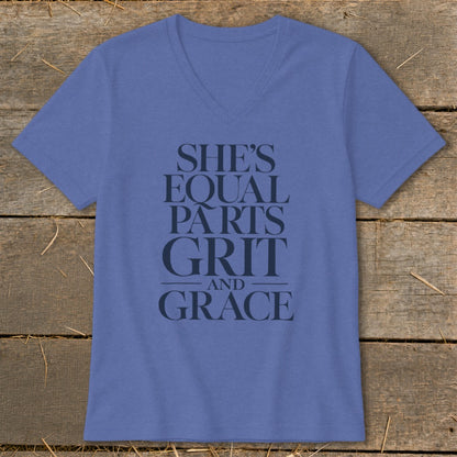 Blue v-neck t-shirt with dark text reading "SHE'S EQUAL PARTS GRIT AND GRACE".