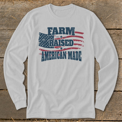 Long sleeve white shirt with distressed American flag and "FARM RAISED AMERICAN MADE" text.