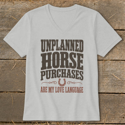 Grey v-neck t-shirt with "UNPLANNED HORSE PURCHASES ARE MY LOVE LANGUAGE" text and horseshoe graphic.