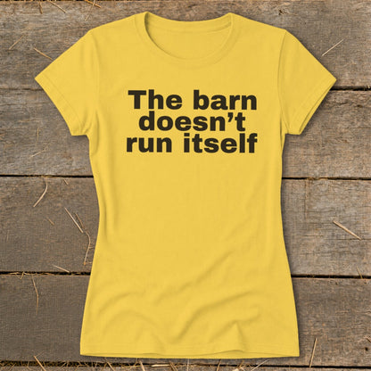 Yellow t-shirt with black text: "The barn doesn't run itself."