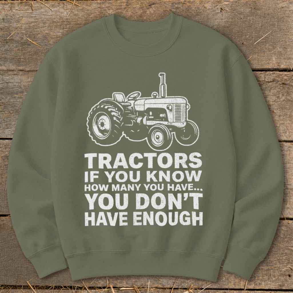 Olive green sweatshirt with white tractor graphic and text: Tractors if you know how many you have... you don't have enough.