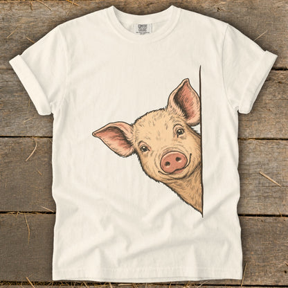 White t-shirt with a peeking pig illustration.