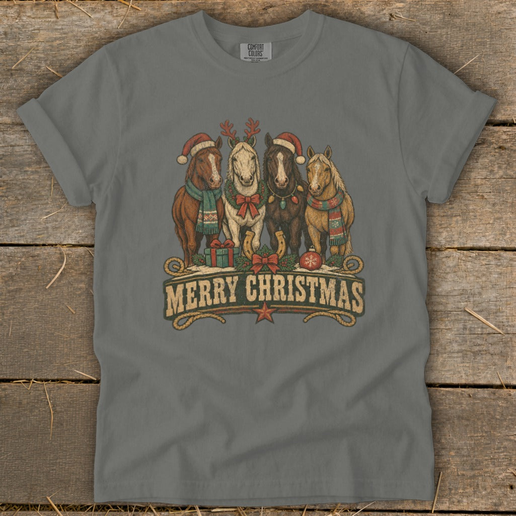 Four horses in Christmas attire below "MERRY CHRISTMAS" text on a gray t-shirt.