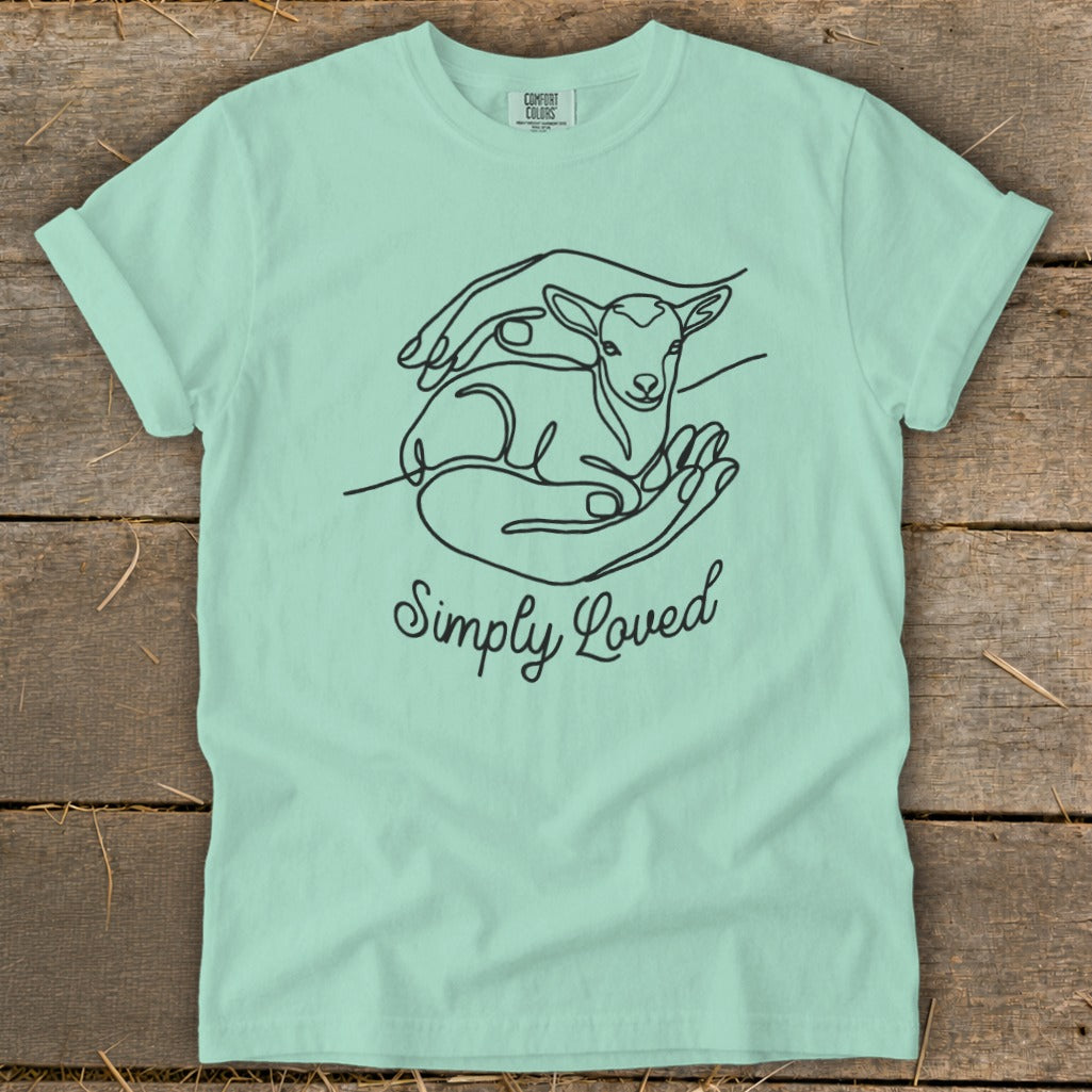 Mint green t-shirt with black line art of a lamb in hands and "Simply Loved".