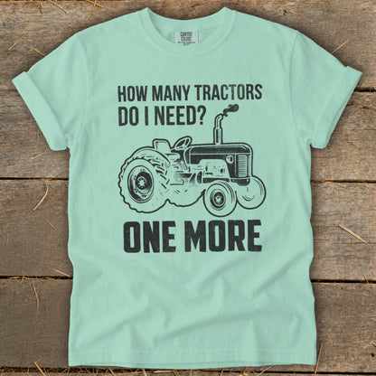Mint green t-shirt with black text and tractor graphic: "How Many Tractors Do I Need? One More."