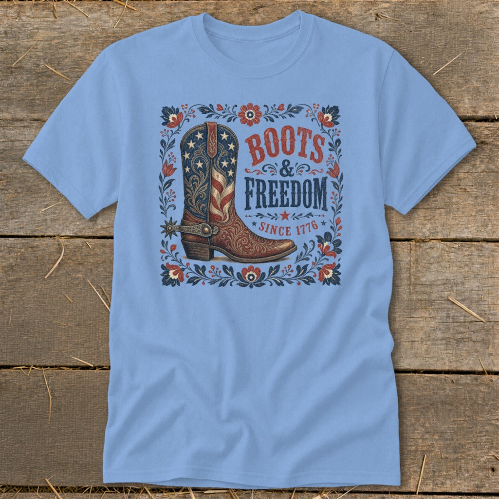 Light blue t-shirt with a graphic of a cowboy boot and text "BOOTS & FREEDOM SINCE 1776".