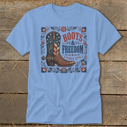 Light blue t-shirt with a graphic of a cowboy boot and text "BOOTS & FREEDOM SINCE 1776".