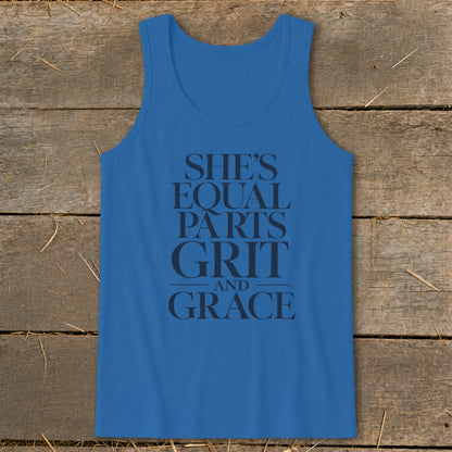 Blue tank top with black text reading "SHE'S EQUAL PARTS GRIT AND GRACE."