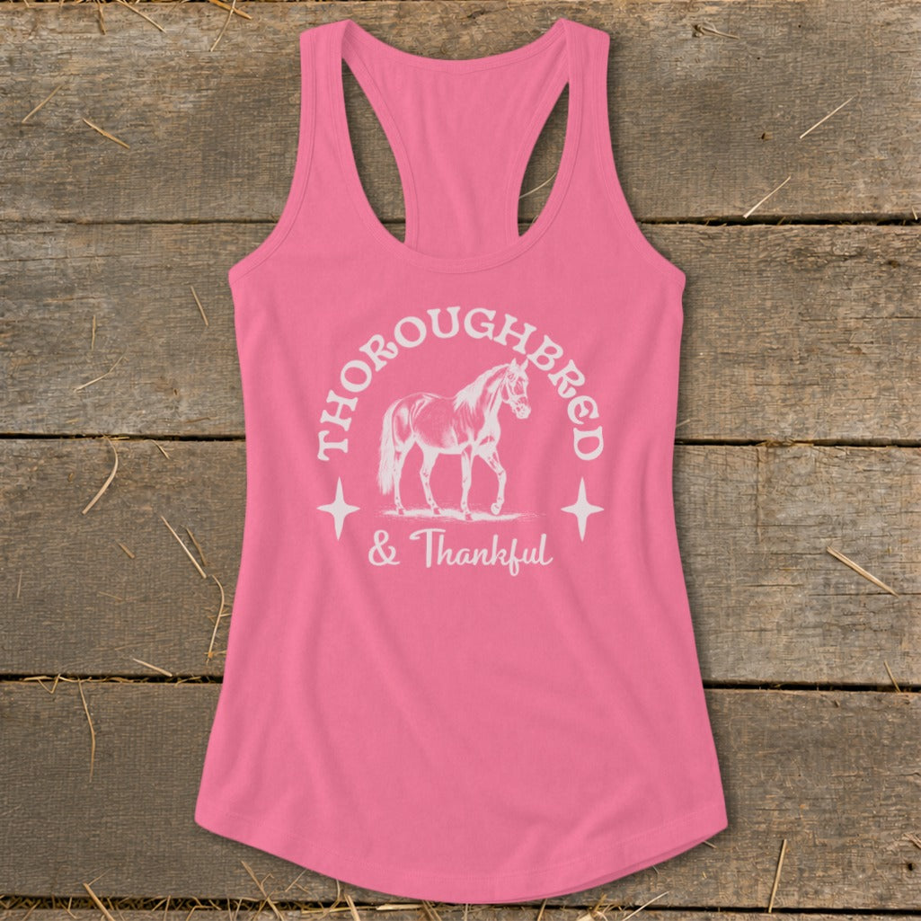 Pink racerback tank top with white "Thoroughbred & Thankful" text and horse graphic.