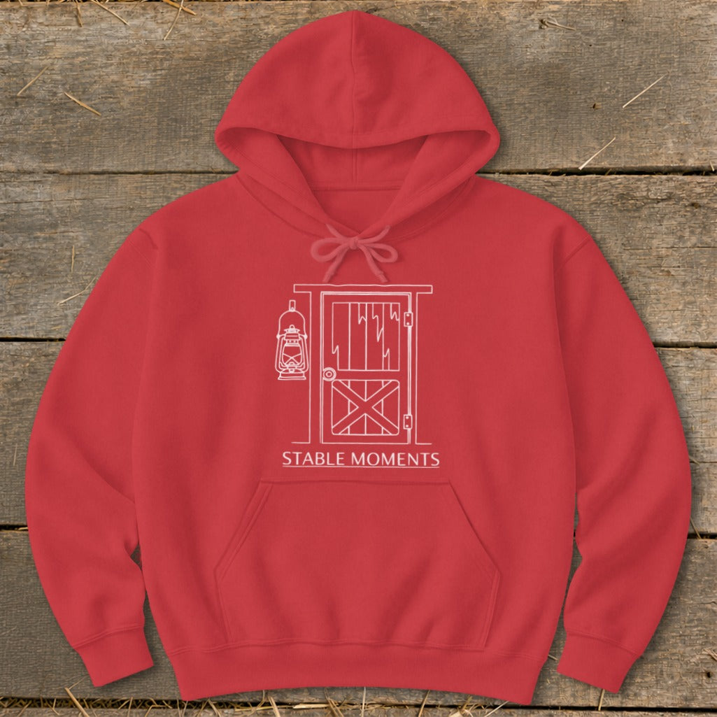 Red hoodie with white line art of a barn door and lantern, reading "STABLE MOMENTS".