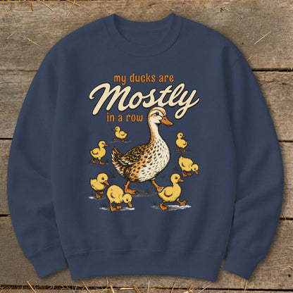 Dark blue sweatshirt with a mother duck and ducklings graphic and text "my ducks are Mostly in a row".