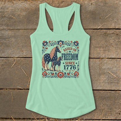 Mint green tank top with horses and text "Raised on Freedom Since 1776".