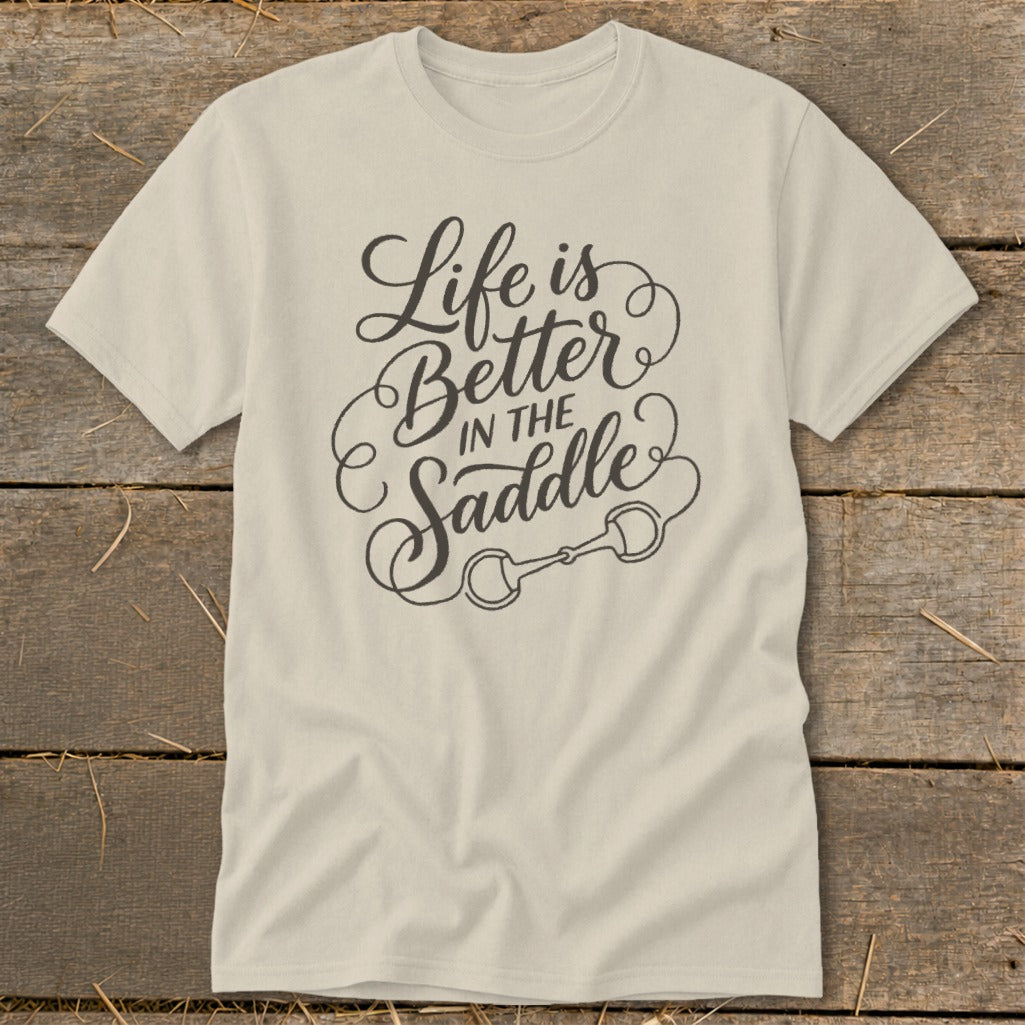 Cream t-shirt with "Life is Better In The Saddle" text and horse bit graphic.