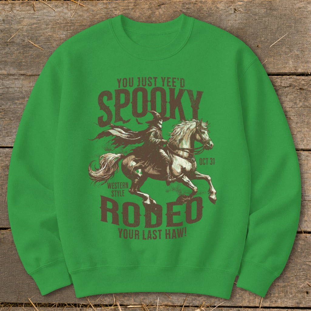 Green sweatshirt with spooky cowboy on horse graphic and text "Spooky Rodeo".