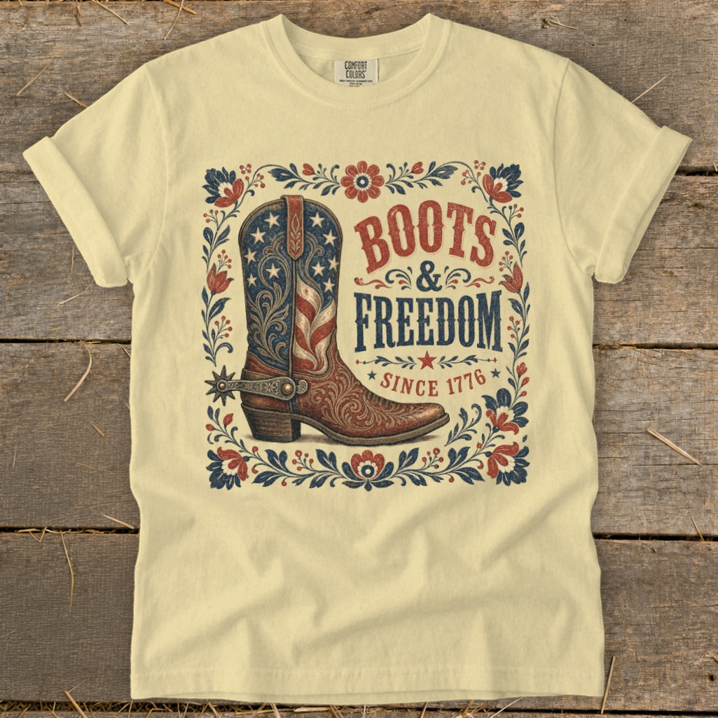 Light yellow t-shirt with "Boots & Freedom Since 1776" text and flag-patterned boot.