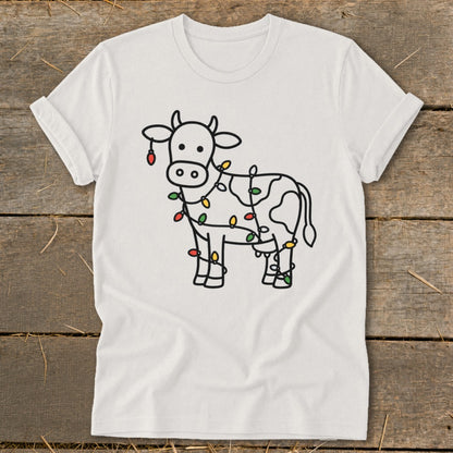 White t-shirt with line drawing of cow wrapped in colorful Christmas lights.