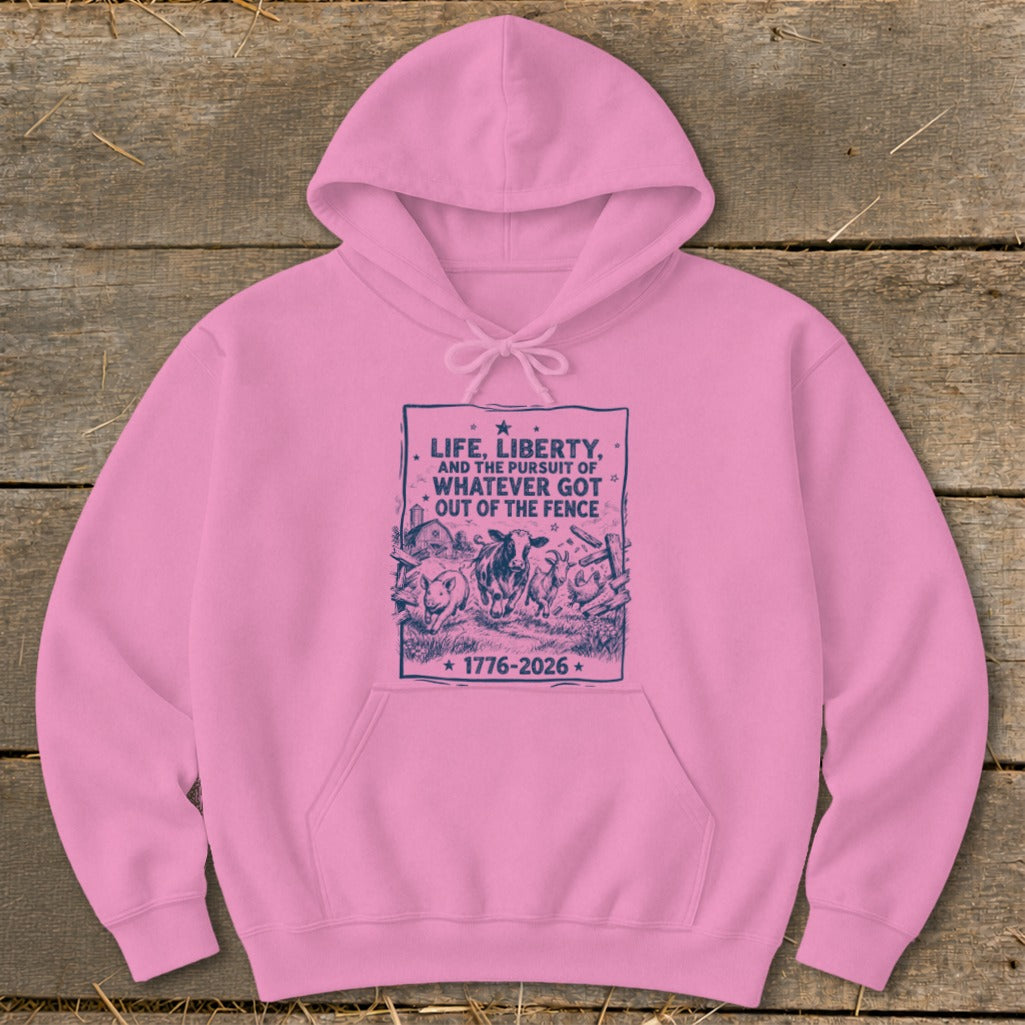 Pink hoodie with dark blue graphic: "Life, Liberty, and the Pursuit of Whatever Got Out of the Fence 1776-2026"