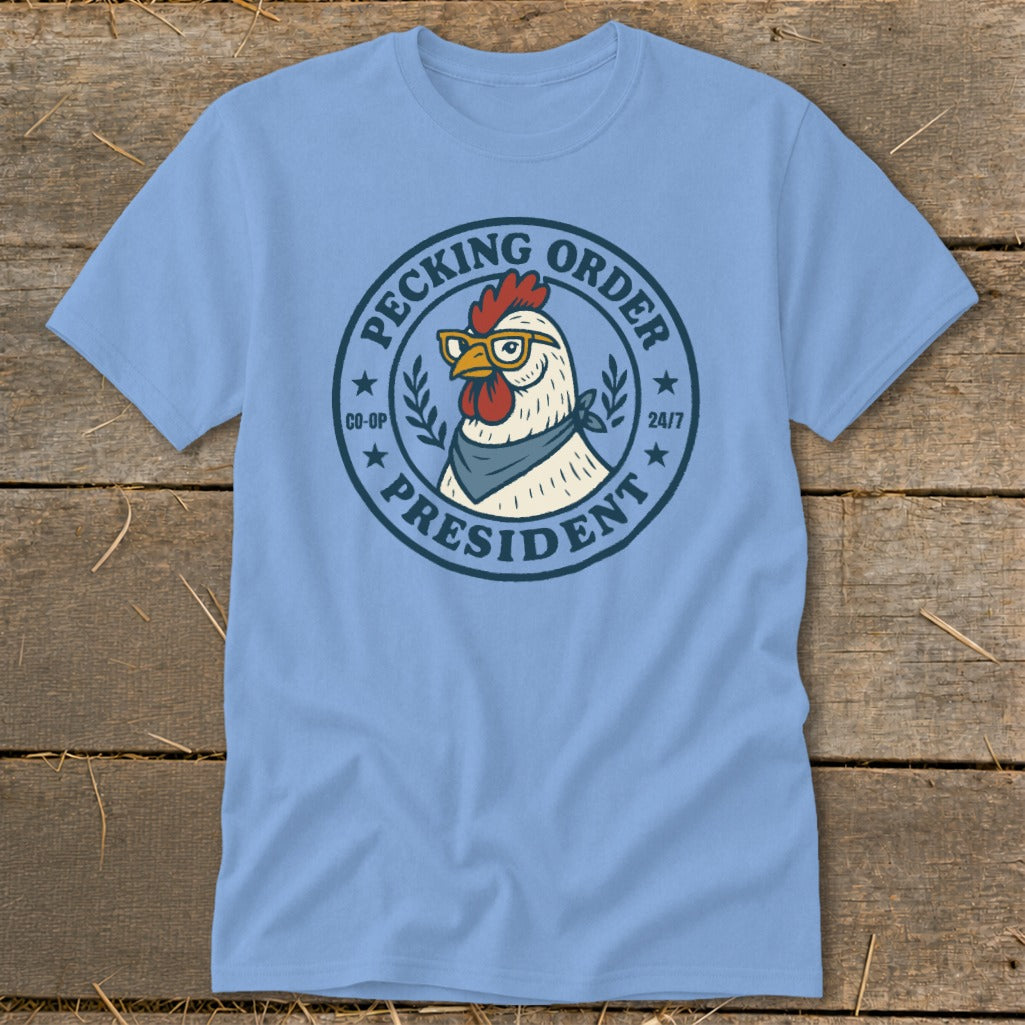 Light blue t-shirt with a chicken wearing glasses and a bandana with "Pecking Order President" text.