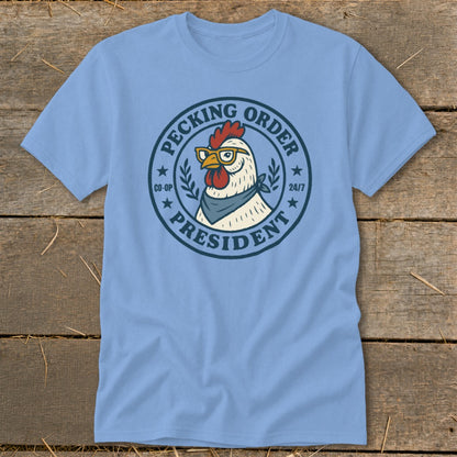 Light blue t-shirt with a chicken wearing glasses and a bandana with "Pecking Order President" text.