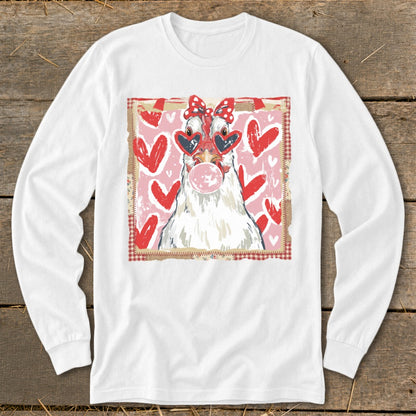 White long-sleeve shirt with a chicken wearing heart sunglasses and a bow, blowing bubblegum.