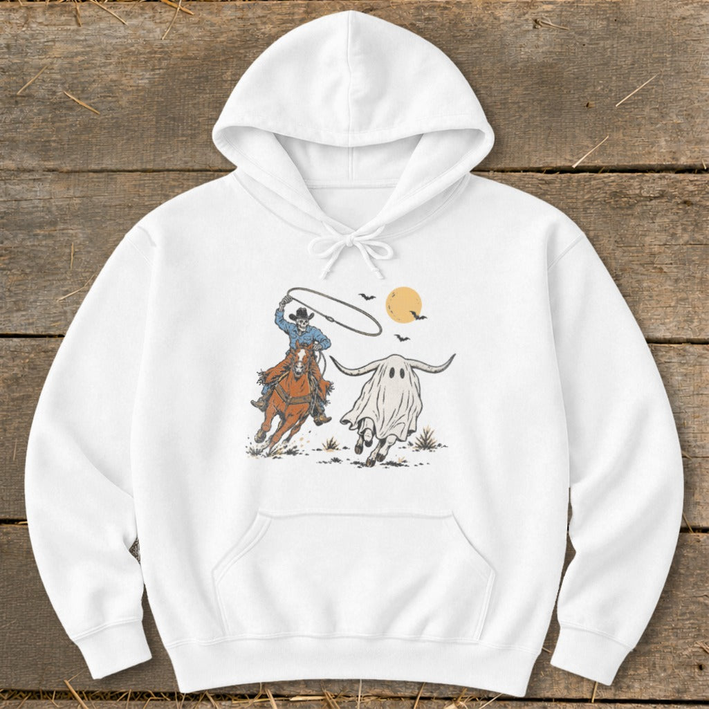 Cowboy skeleton on horse lassos a ghost longhorn under a full moon.