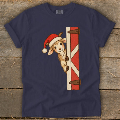 Navy t-shirt with a drawing of a goat in a Santa hat peeking around a barn door.