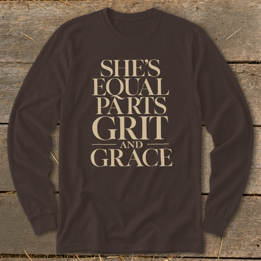 Brown long-sleeve shirt with text "SHE'S EQUAL PARTS GRIT AND GRACE".